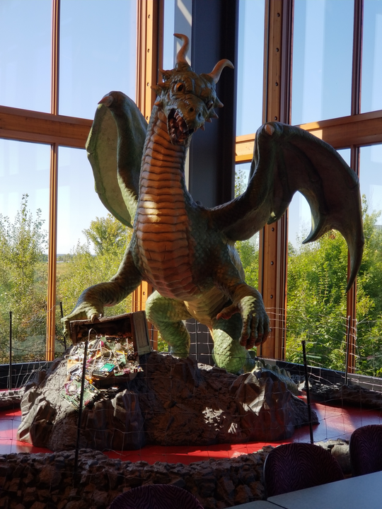 Dragon guarding a hoard in a conference room